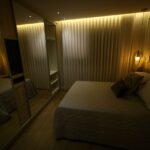 A warm and elegant bedroom with cozy lighting and modern furnishings.