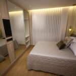A cozy modern bedroom with elegant interior design and soft lighting.