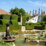 Discover the beautiful Jardim do Paço Episcopal with its lush greenery and historic statues in Portugal.