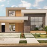 Contemporary house exterior with minimalist design, large windows, and landscaped front yard.